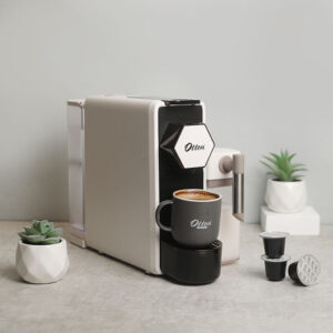 Nespresso capable capsule machine with milk container